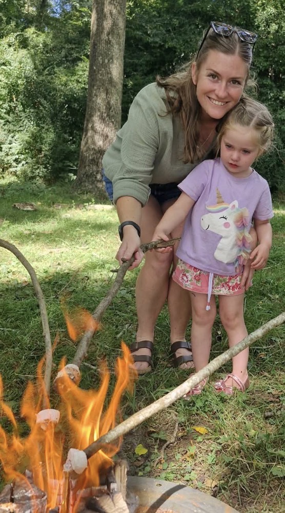 Megan, qualified teacher with child outdoors